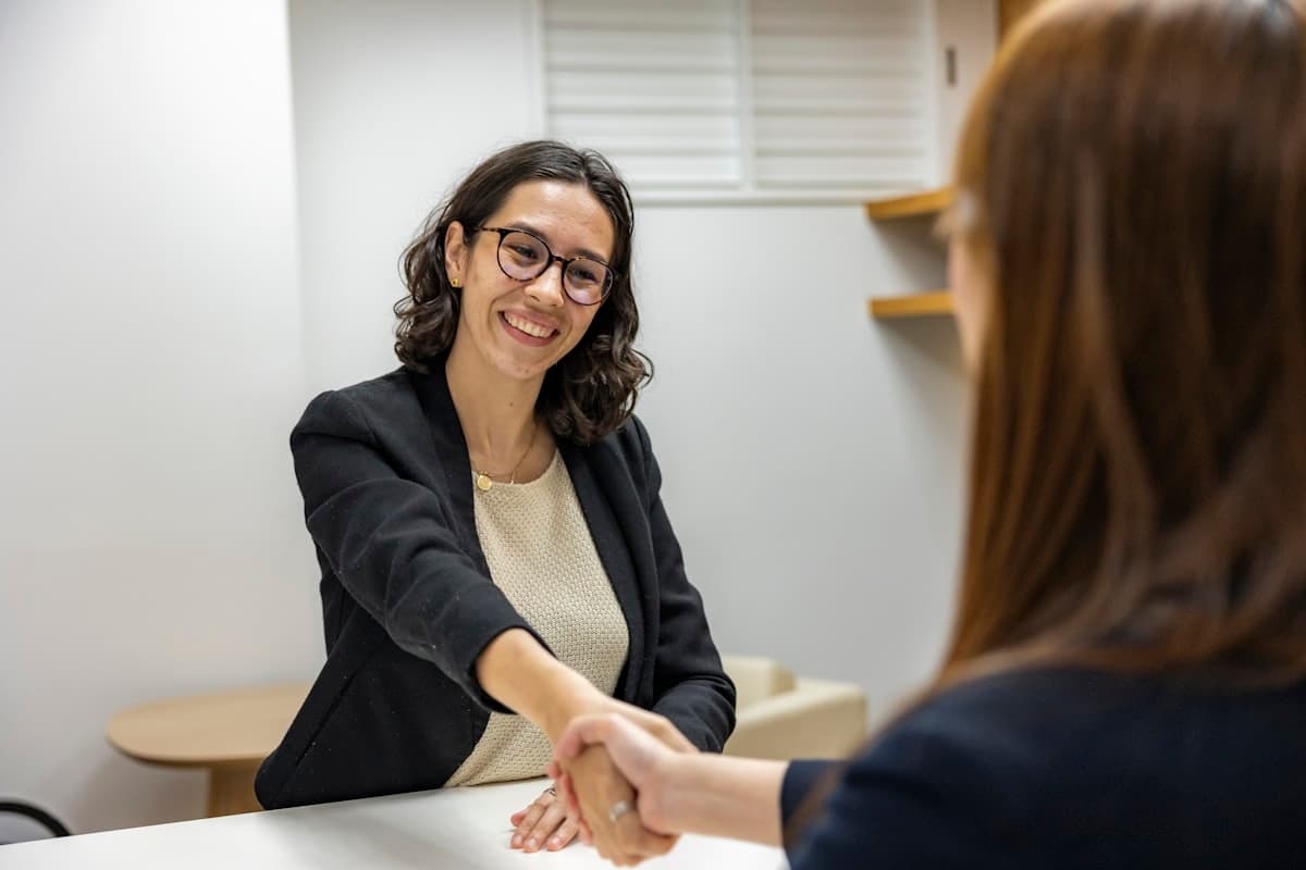 Employer welcoming a new hire with a handshake